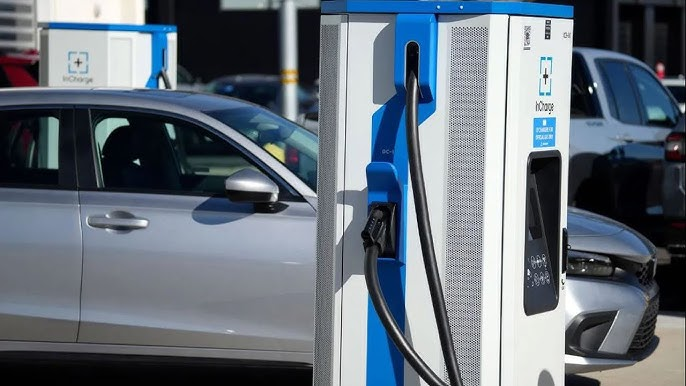 An EV being charged at an EV charging station.