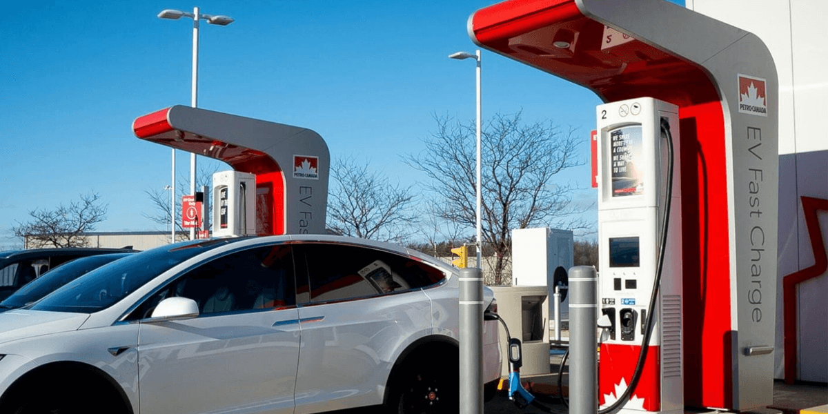 An electric car being charged at a public charging station in Canada