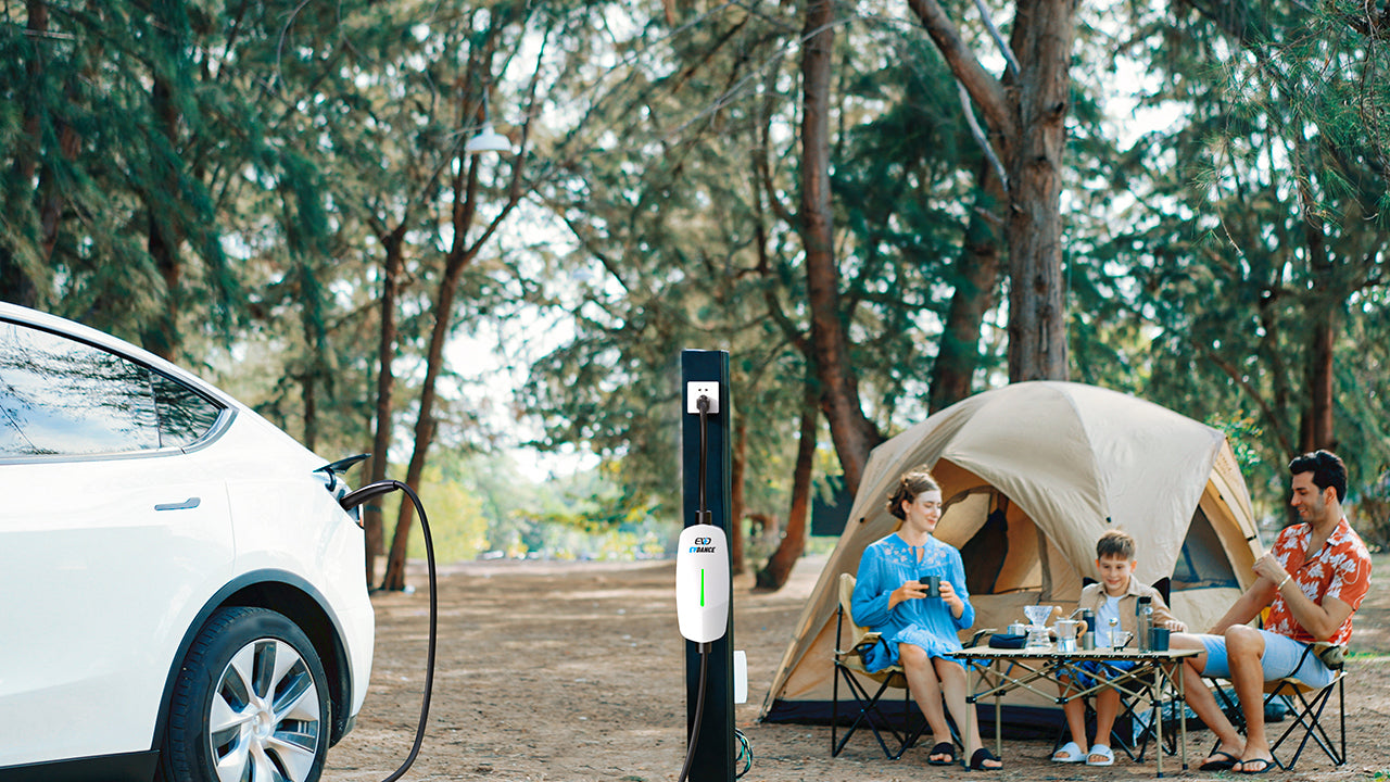 A family camping in the woods while charging their EV with EVDANCE portable charger.