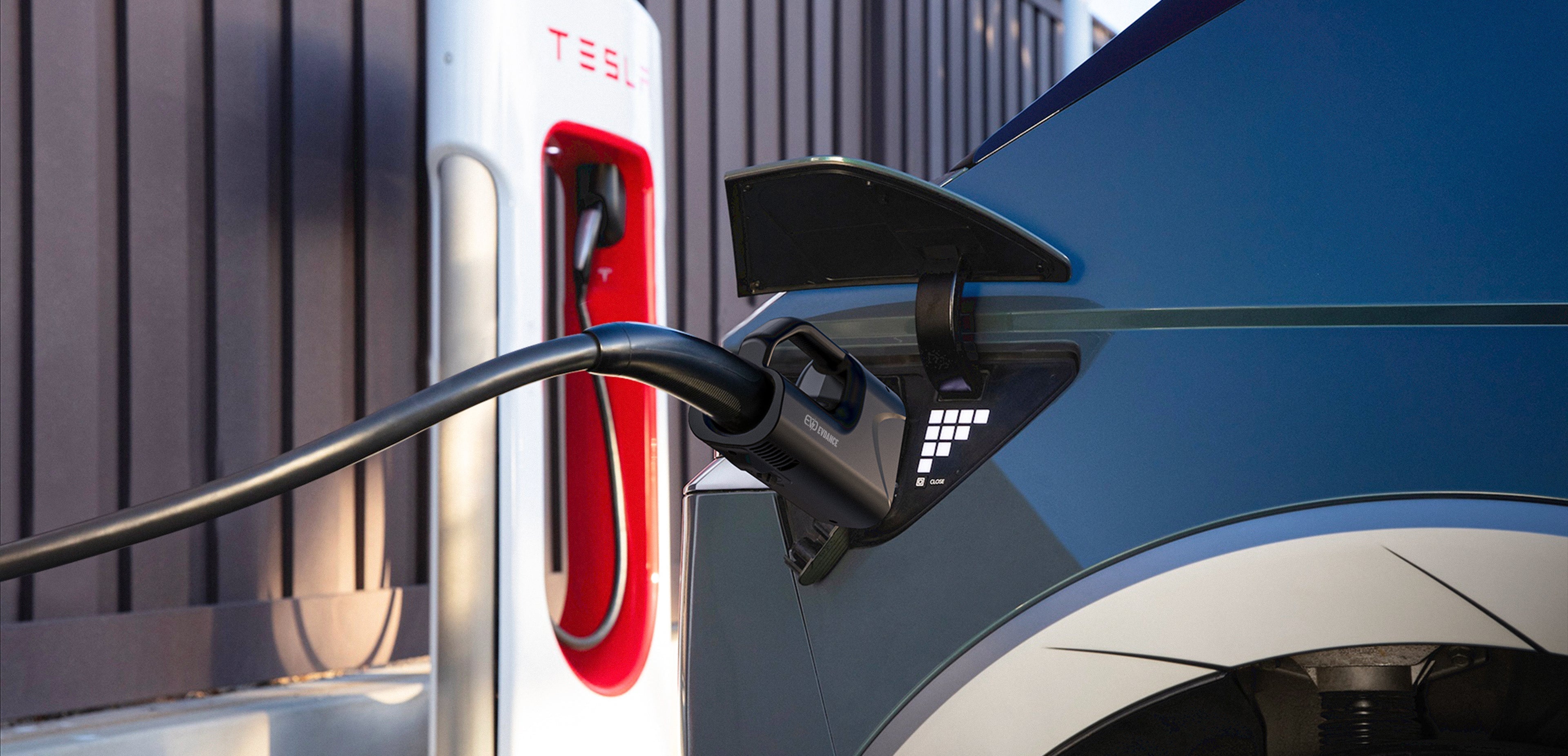 An EV is charging by Tesla Supercharger with EVDANCE Pulse Fusion adapter.