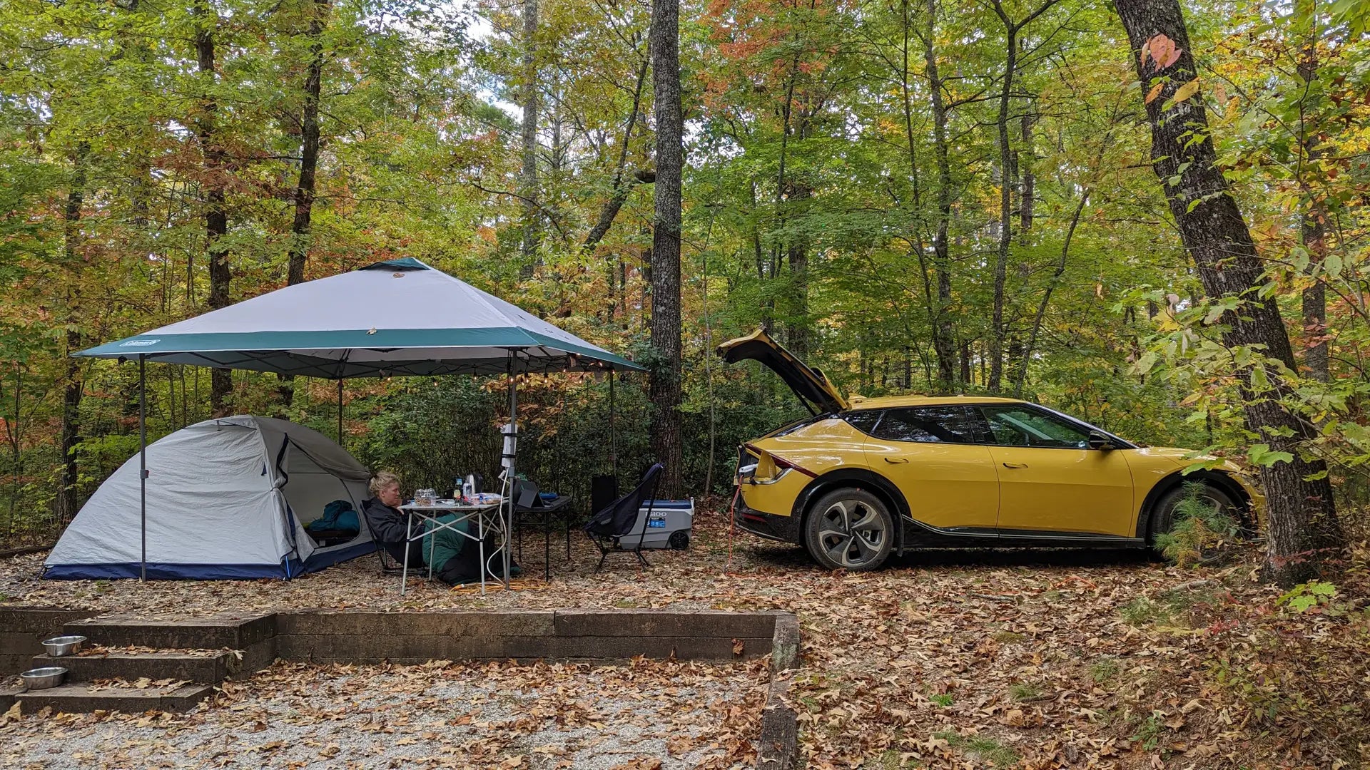 KIA vehicle using V2L adapter to charge camping gear.