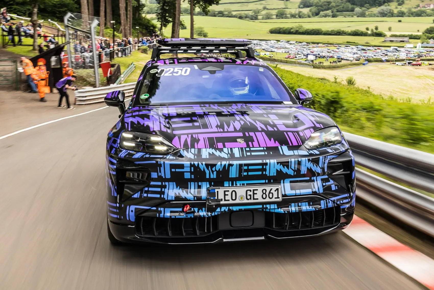 Porsche Cayenne EV racing on the road.