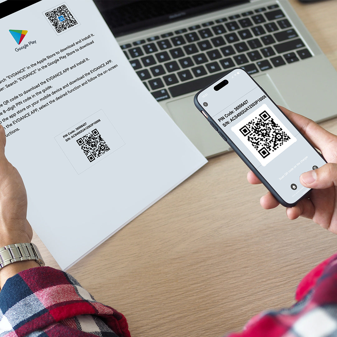 An EVDANCE Flux 40A charger user is using his iPhone to scan the QR code on the product brochure to download the app!