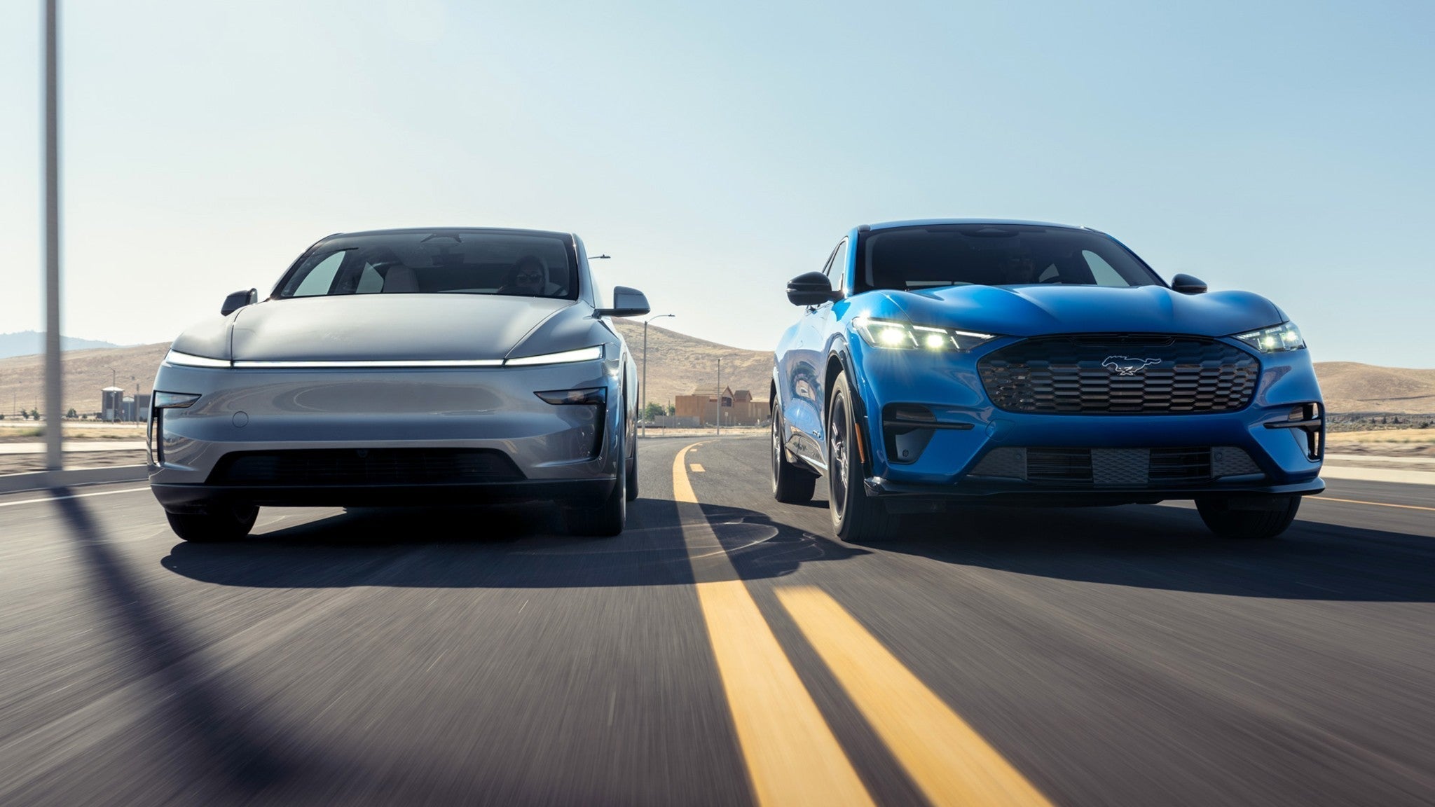 Model Y and Mach-e driving side by side on the road.