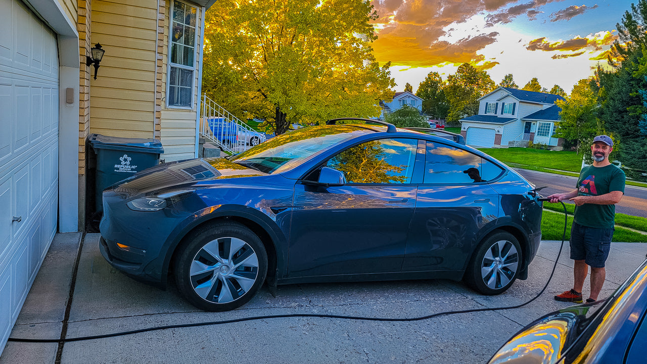 A Tesla owner is using the EVDANCE Tesla Extension Cord to charge his Tesla car parked outside his garage by connecting it to the EVDANCE Tesla Charger wired from an outlet inside his detached apartment!