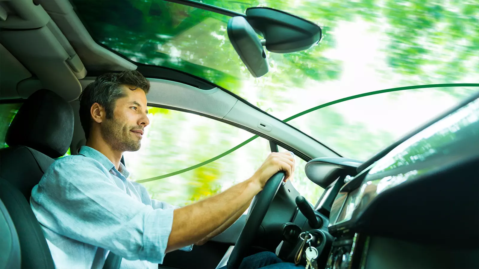An adult man EV driver driving an EV.