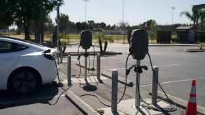 An EV is charging at a public charging station in California.