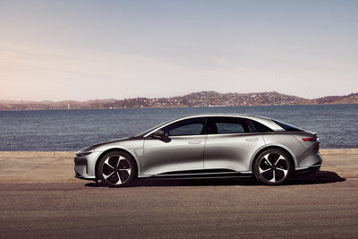 Silver Lucid Air driving on the road.