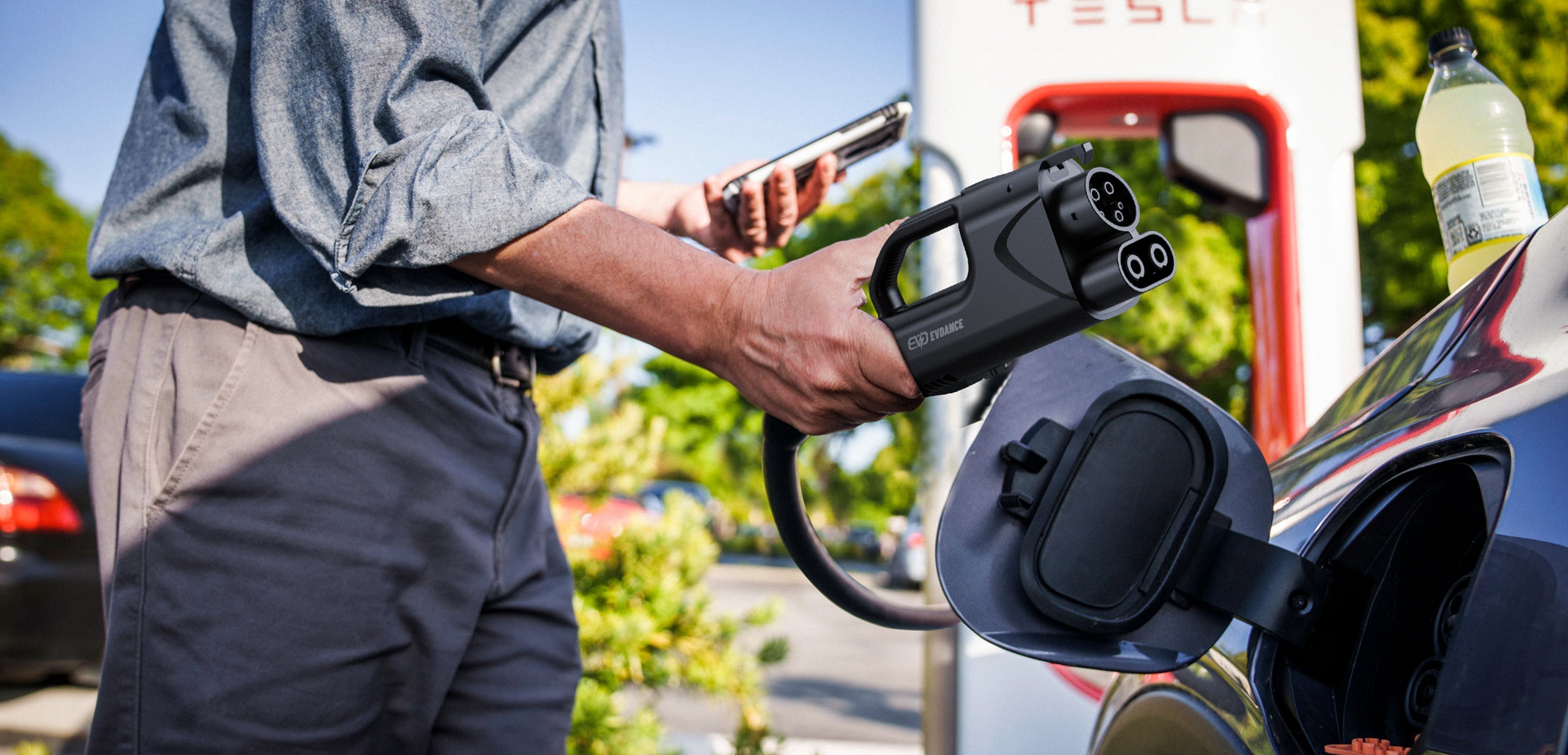 A man using EVDANCE Pulse Fusion adapter to connect with Tesla Supercharger.