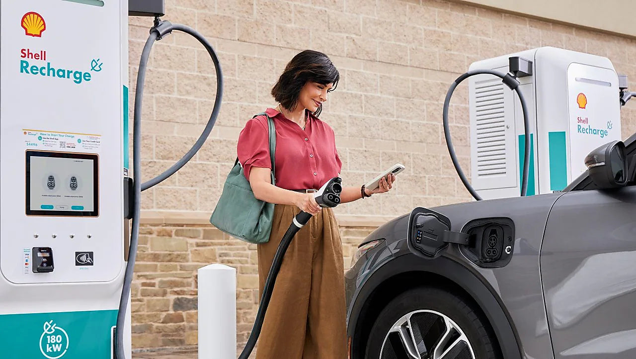 Girl at the Shell Recharge charging station.