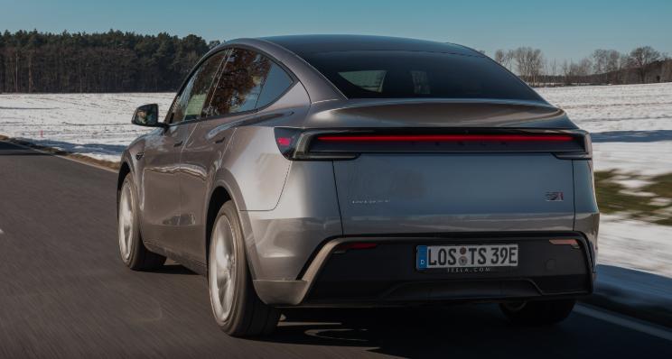A Tesla Model Y driving on the road.