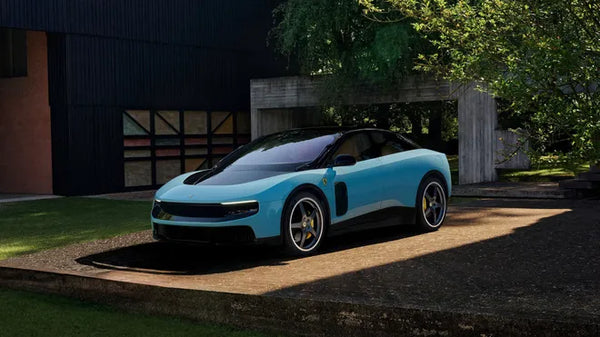 Blue Ferrari Luce parked on a driveway with a modern house and trees in the background